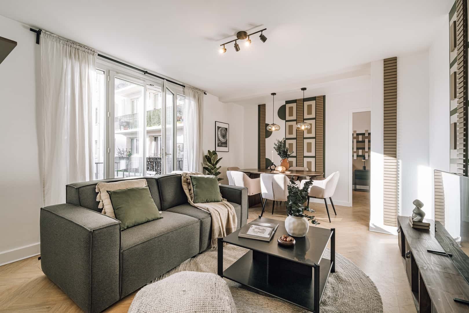 Gray sofa coffee table dining table living room at Apartment in 191 Rue St Charles, 75015 Paris, France in Paris Student Accommodation