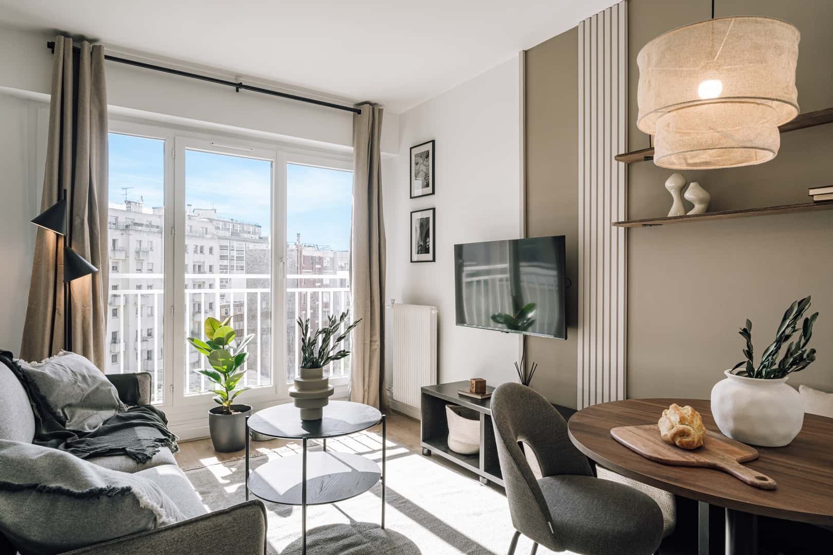 Sofa TV dining table with chairs living room at Apartment in 146 Bd de Grenelle, 75015 Paris, France in Paris Student Accommodation