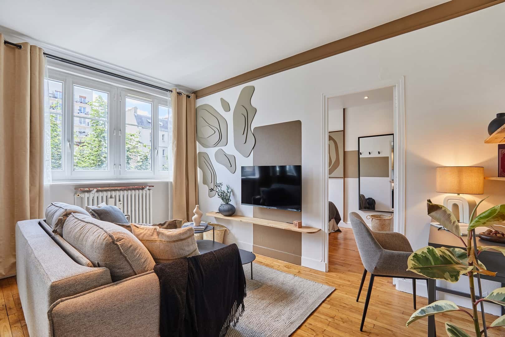 Sofa TV and patterned wall Living room at Apartment in 41 Rue Blomet, 75015 Paris, France in Paris Student Accommodation