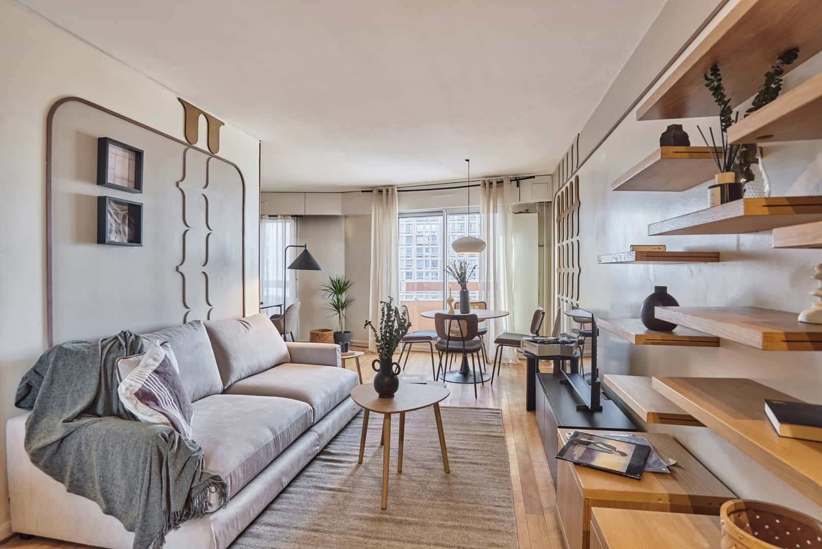 Sofa coffee table dining area and shelves living room at Apartment in 17 Av. d'Italie, 75013 Paris, France in Paris Student Accommodation