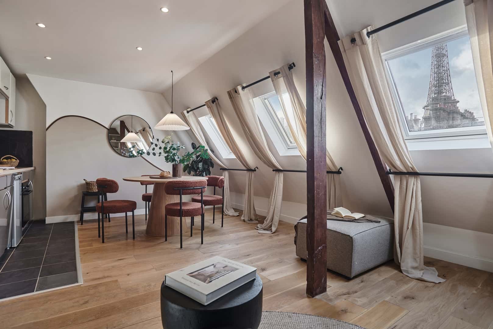Dining table four chairs mirror Eiffel Tower view living room at Apartment in 191 Rue de l'Université, 75007 Paris, France in Paris Student Accommodation