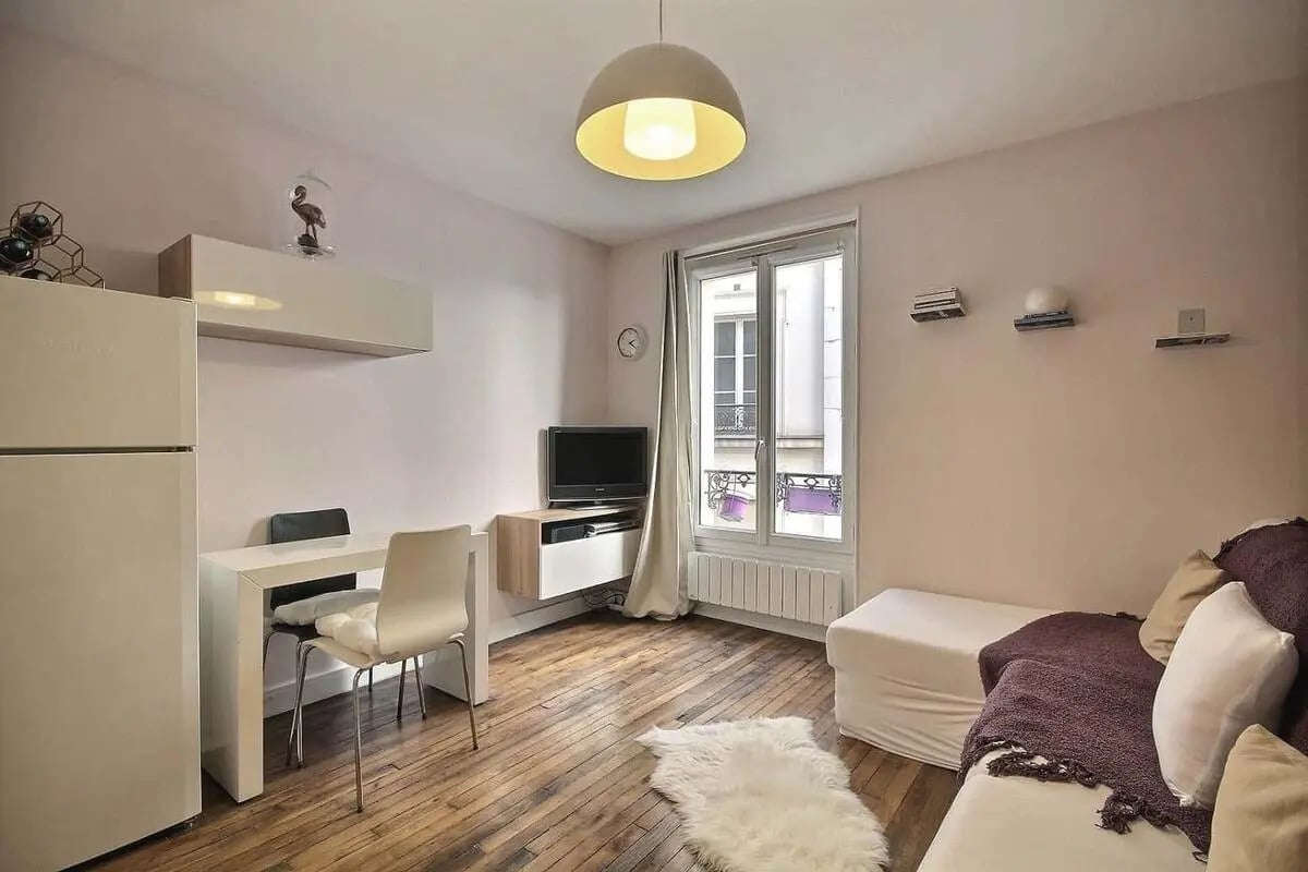 Fridge table chairs TV sofa living room at Apartment in Rue Saint-Dominique, 75007 Paris, France in Paris Student Accommodation