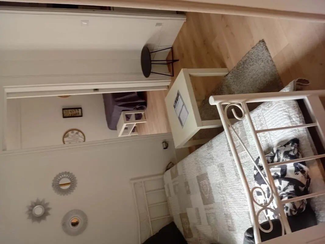 Bed white metal frame bedside table living room at Apartment in 41 Rue Mazarine, 75006 Paris, France in Paris Student Accommodation