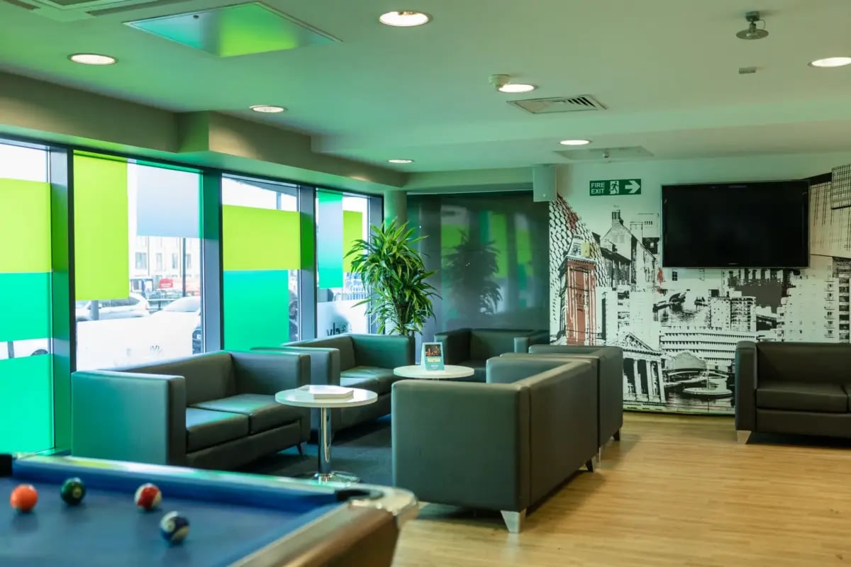 Pool table sofas lounge area with mural living room at Belgrave View in Birmingham Student Accommodation