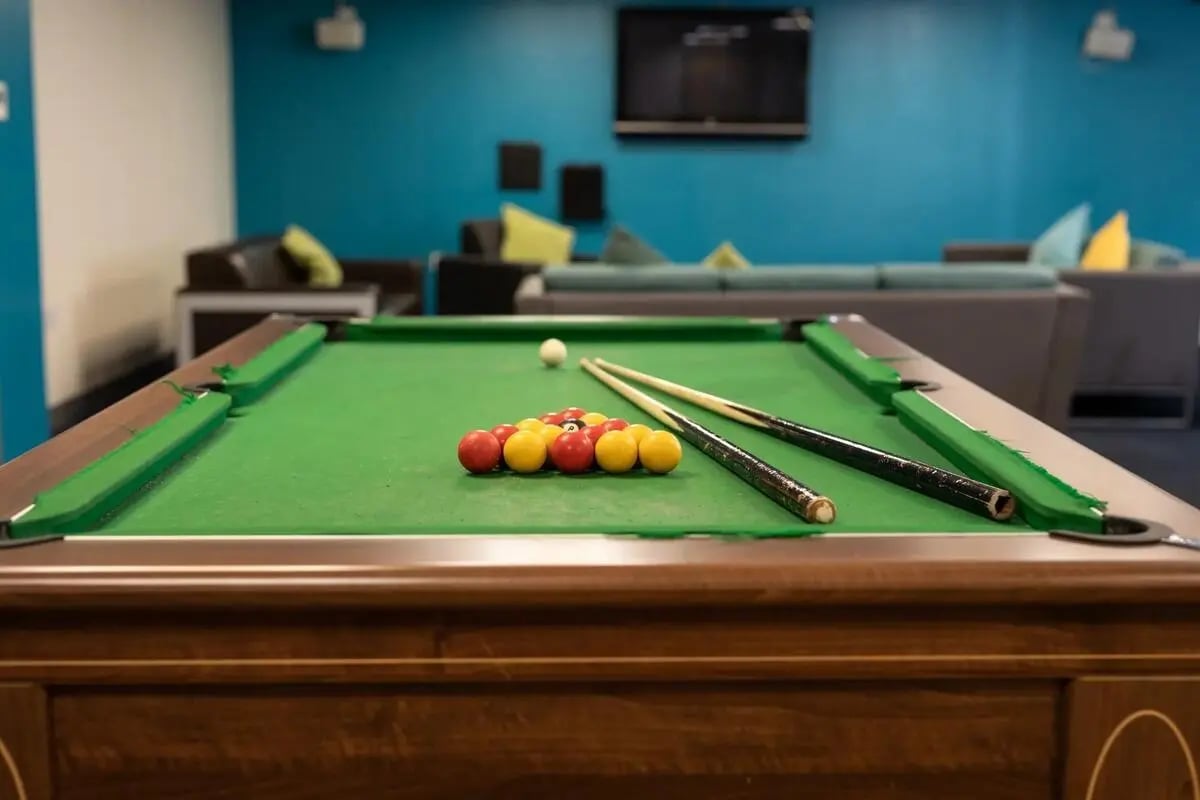 Pool table with balls and cues playing area at Burley Road in Leeds Student Accommodation