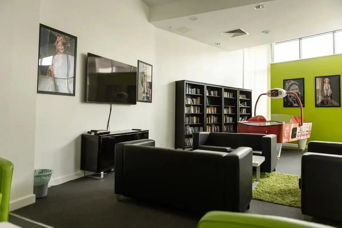 Sofa TV bookshelf air hockey table common room at Bonington Student Village in Loughborough Student Accommodation