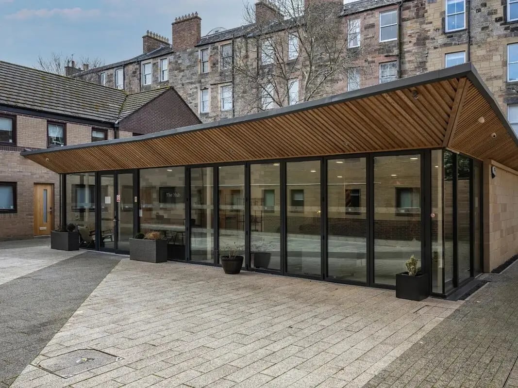 Modern building entrance with glass walls exterior at Meadow Court in Edinburgh Student Accommodation