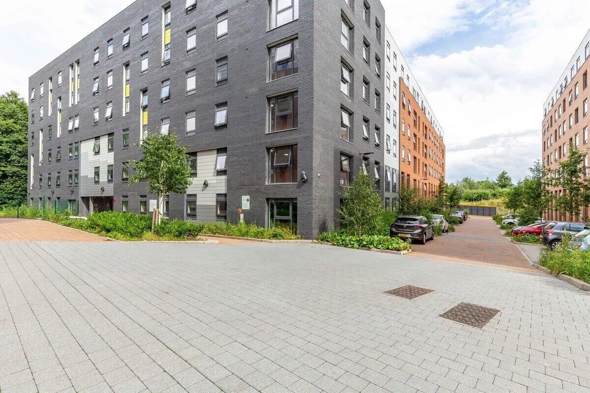 Modern student housing exterior with parking and greenery. Exterior. at Newton Court in Newcastle Upon Tyne Student Accommodation