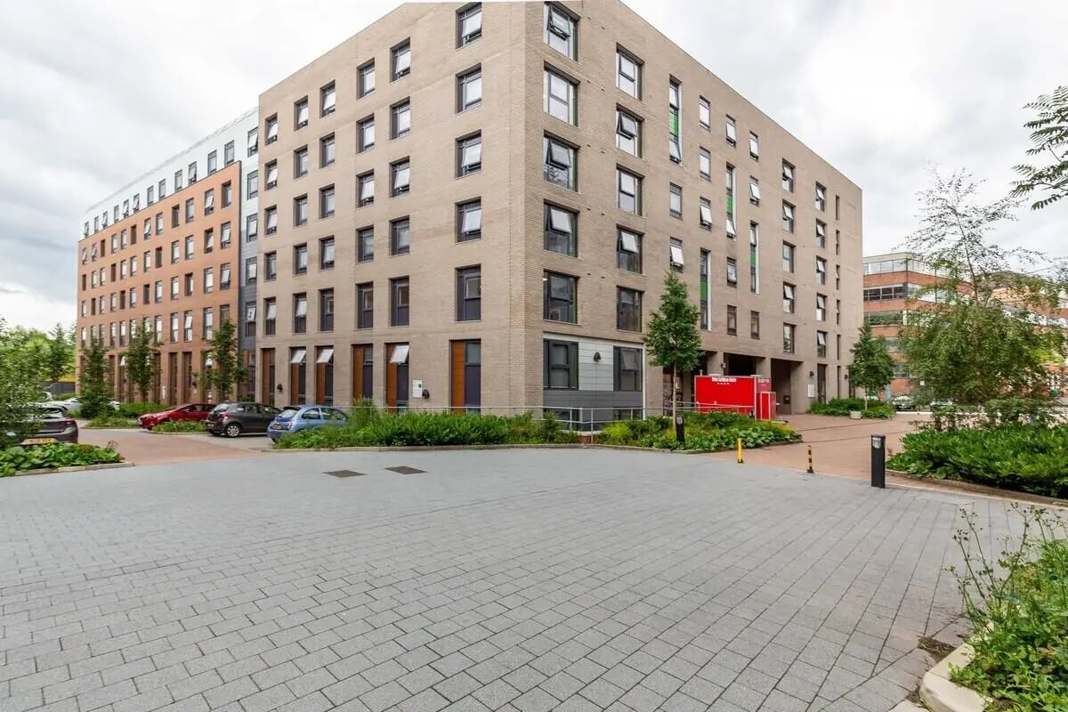 Brick building with cars and trees exterior at Bryson Court in Newcastle Upon Tyne Student Accommodation