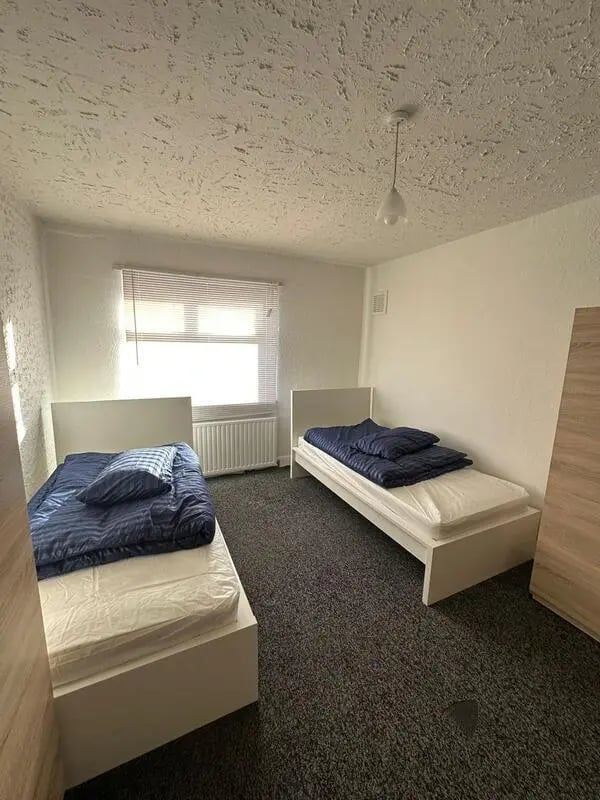 Two white beds with blue bedding bedroom at E16 3LL, MacGregor Rd, London in London Student Accommodation