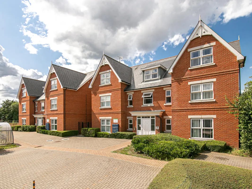 Brick building with white windows and hedges exterior at Parham Student Village in Canterbury Student Accommodation