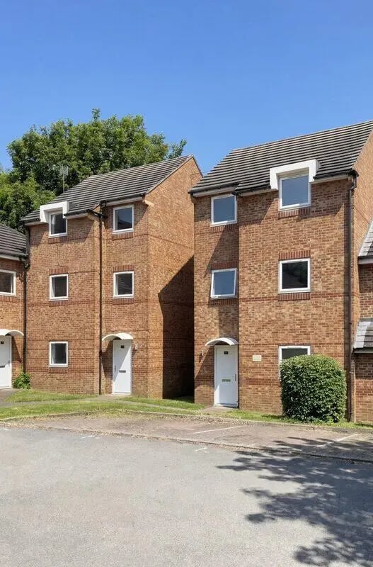 Brick townhouses with white doors and windows exterior at Park Village in Sheffield Student Accommodation