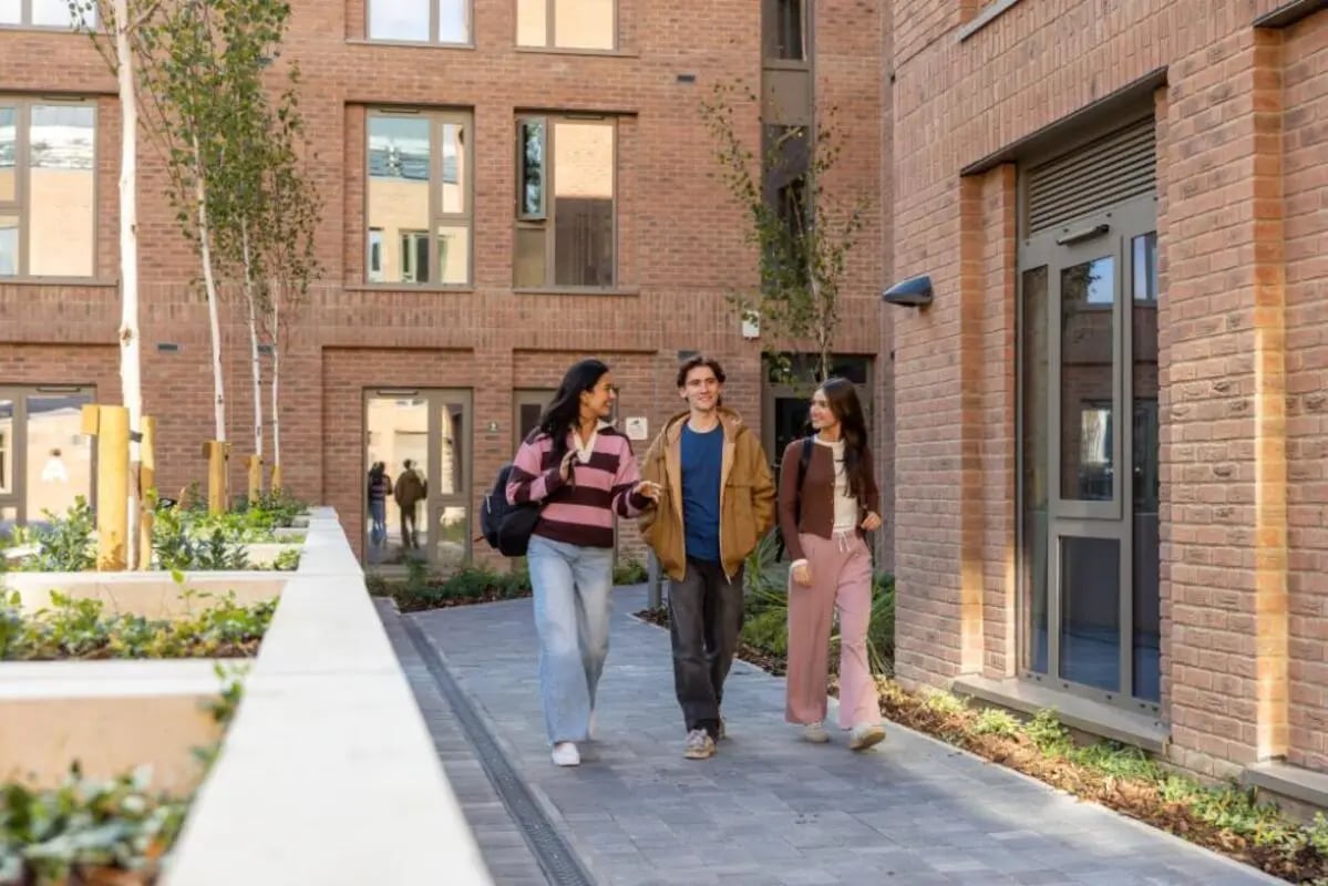 Students walking by modern brick building exterior at Fusion Students York in York Student Accommodation