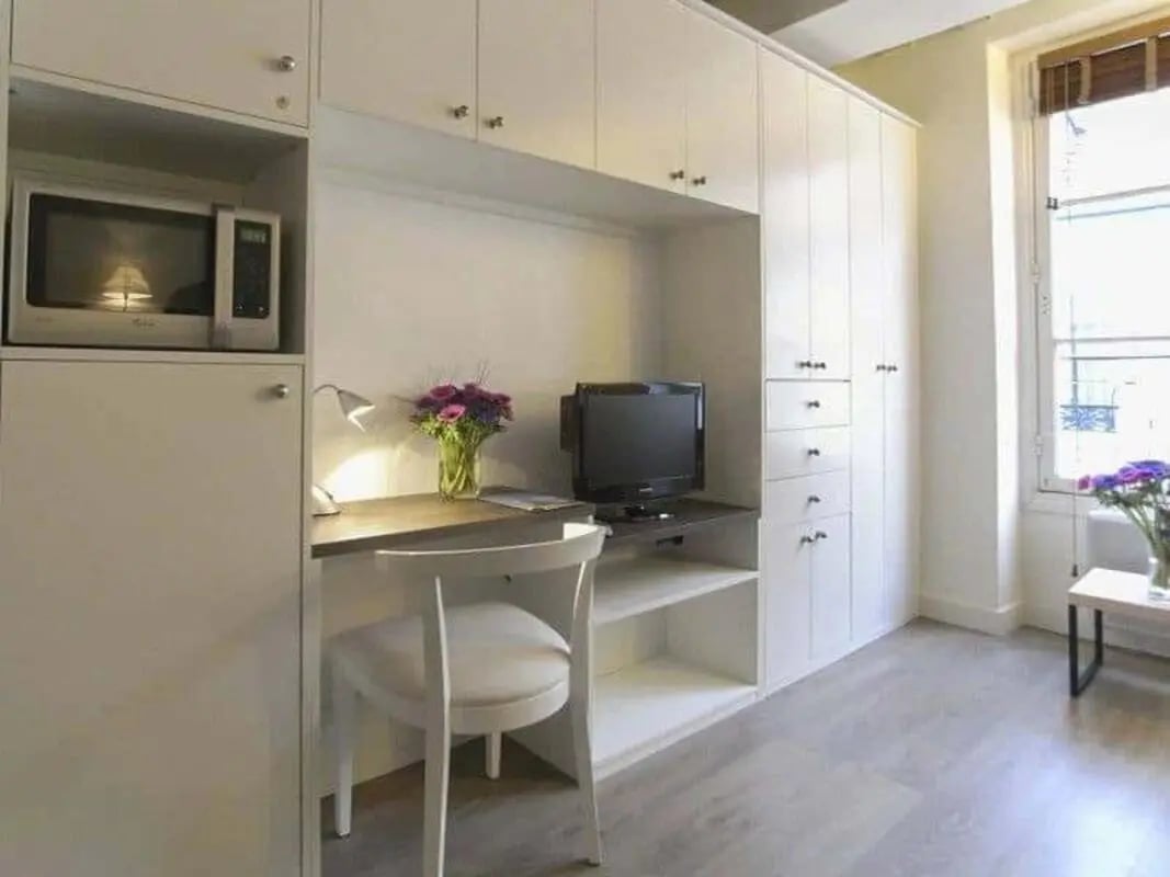 Microwave desk TV and chair student studio bedroom at Studio in 55 Rue Charlot, 75003 Paris, France in Paris Student Accommodation