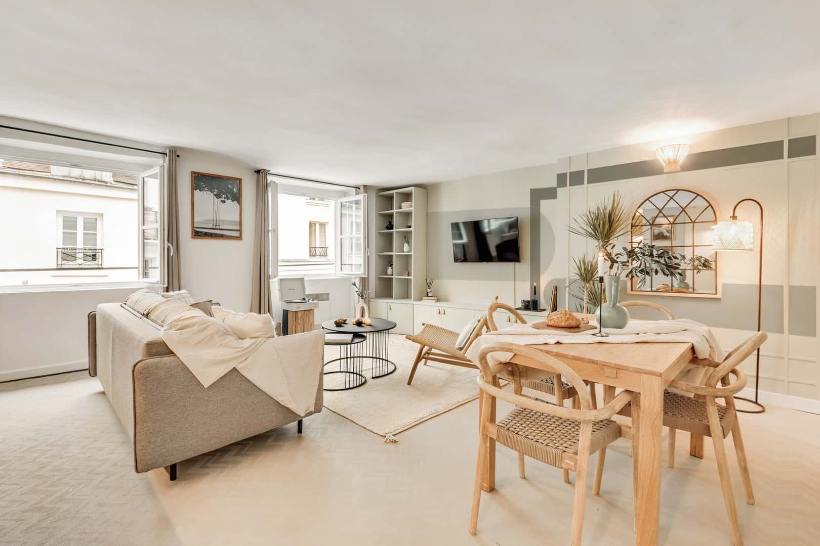 Sofa chairs dining table plants mirror living room at Studio in 54 Rue de Seine, 75008 Paris, France in Paris Student Accommodation