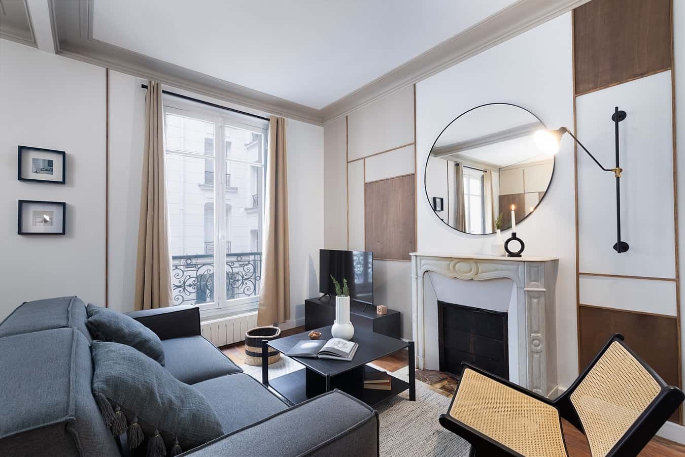 Gray sofa fireplace mirror chairs living room at Apartment in 11 Rue du Perche, 75003 Paris, France in Paris Student Accommodation