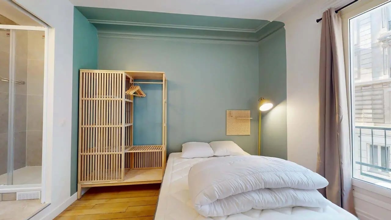 Bed and wardrobe with shower and lamp bedroom at Room in 94 Rue de Crimée, 75019 Paris, France in Paris Student Accommodation