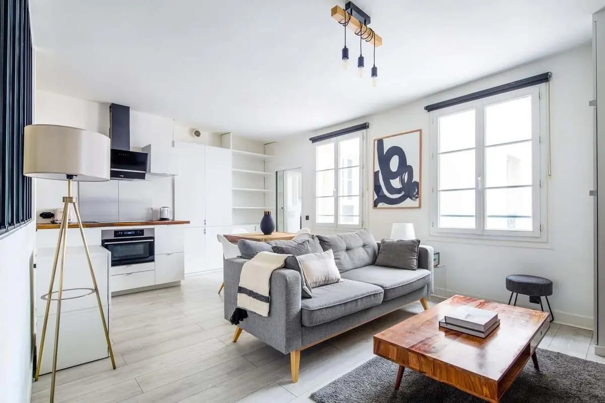 Modern living room with grey sofa and kitchen living room at Apartment in 70 Rue Mazarine, 75006 Paris, France in Paris Student Accommodation