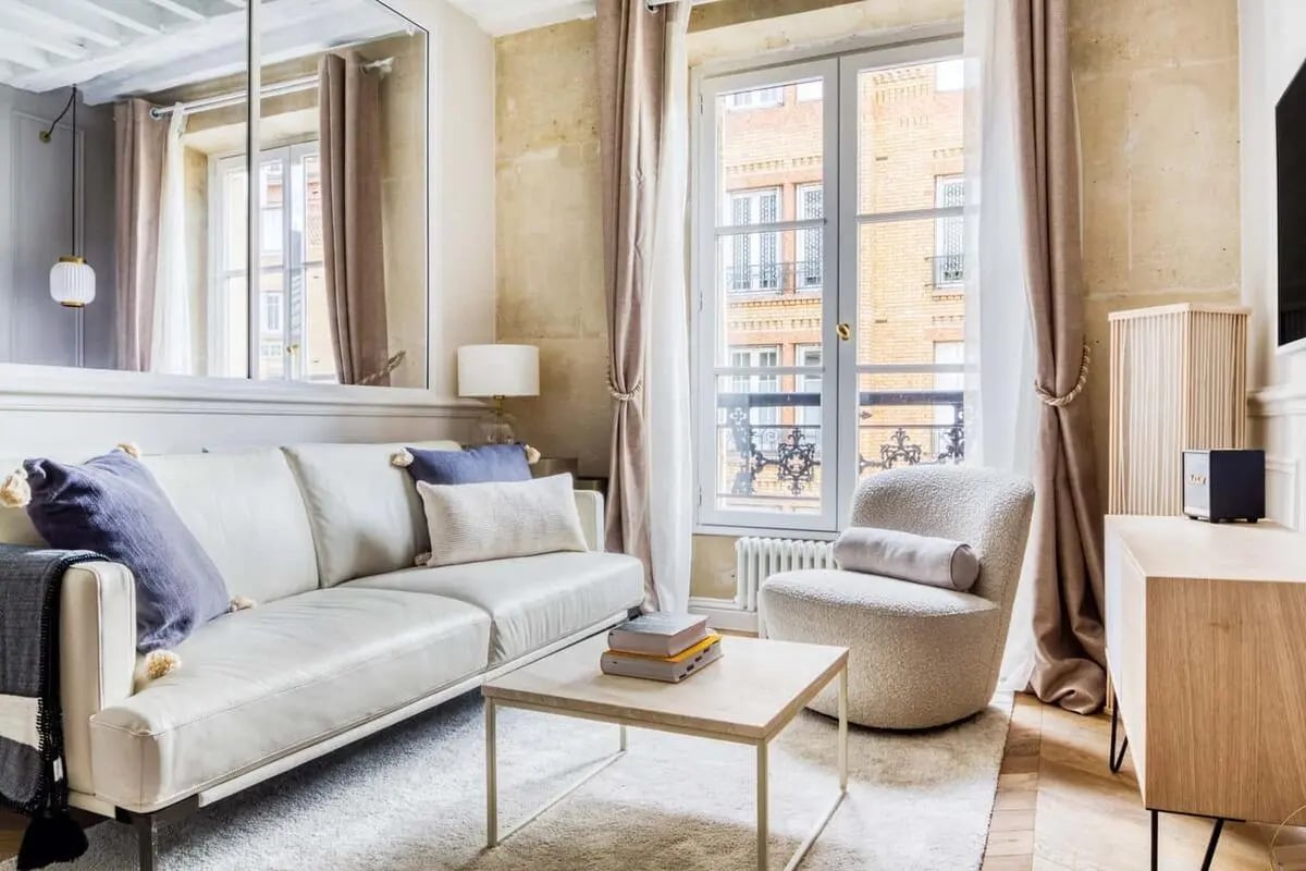 White sofa armchair coffee table lamp living room at Apartment in 56 Rue de Babylone, 75007 Paris, France in Paris Student Accommodation