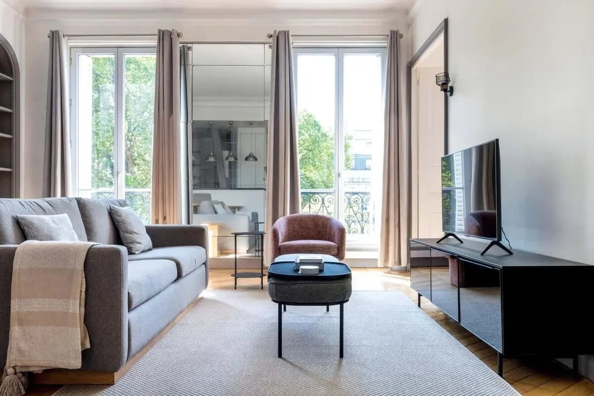 Sofa armchair coffee table television living room at Apartment in 6 Rue Pierre Semard, 75009 Paris, France in Paris Student Accommodation