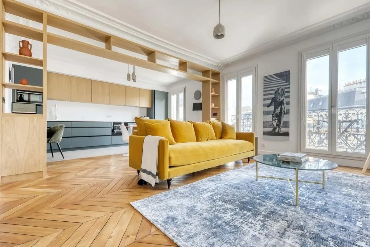 Yellow sofa glass coffee table patterned rug living room at Apartment in 35 Rue Marguerite de Rochechouart, 75009 Paris, France in Paris Student Accommodation