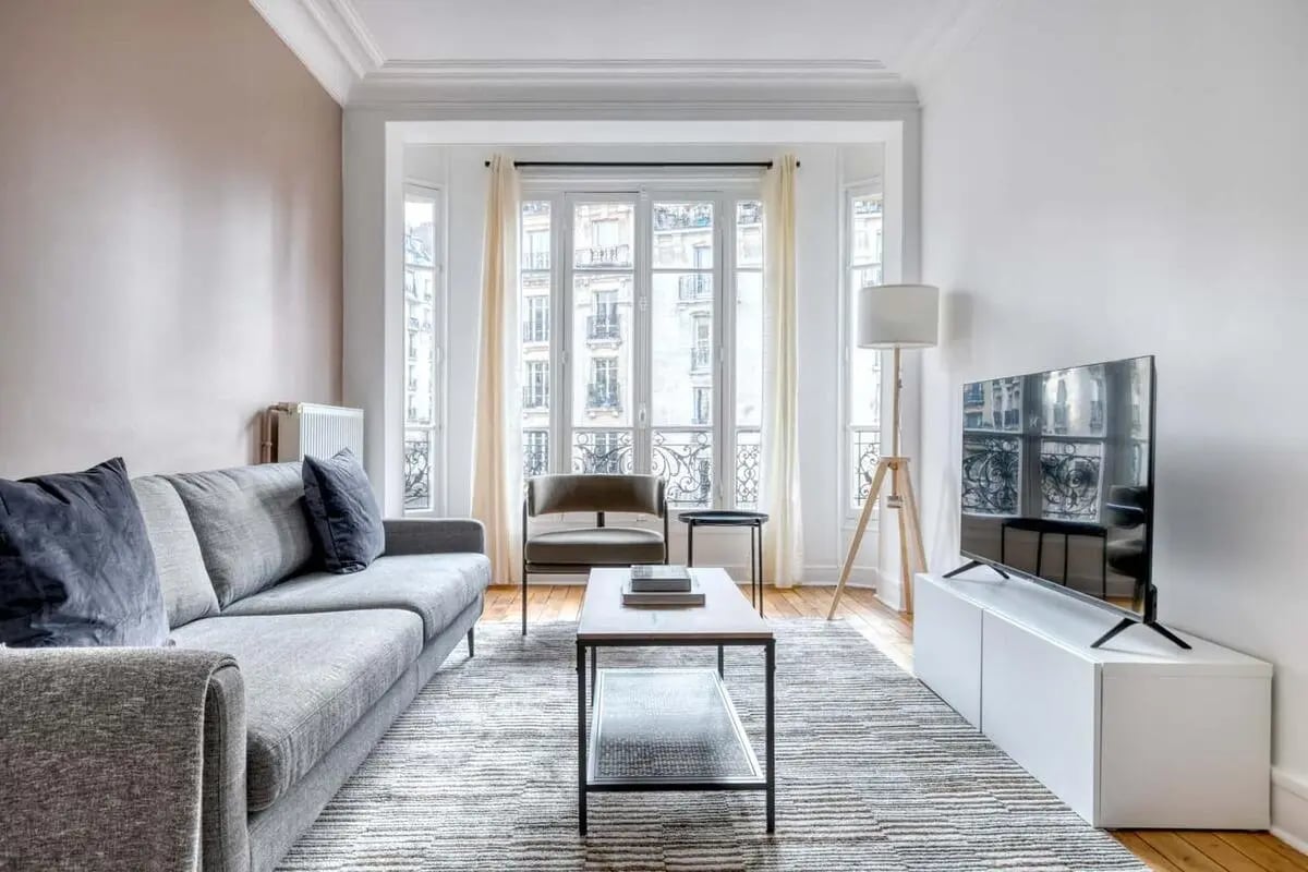 Sofa coffee table television floor lamp living room at Apartment in 111 Rue Caulaincourt, 75018 Paris, France in Paris Student Accommodation