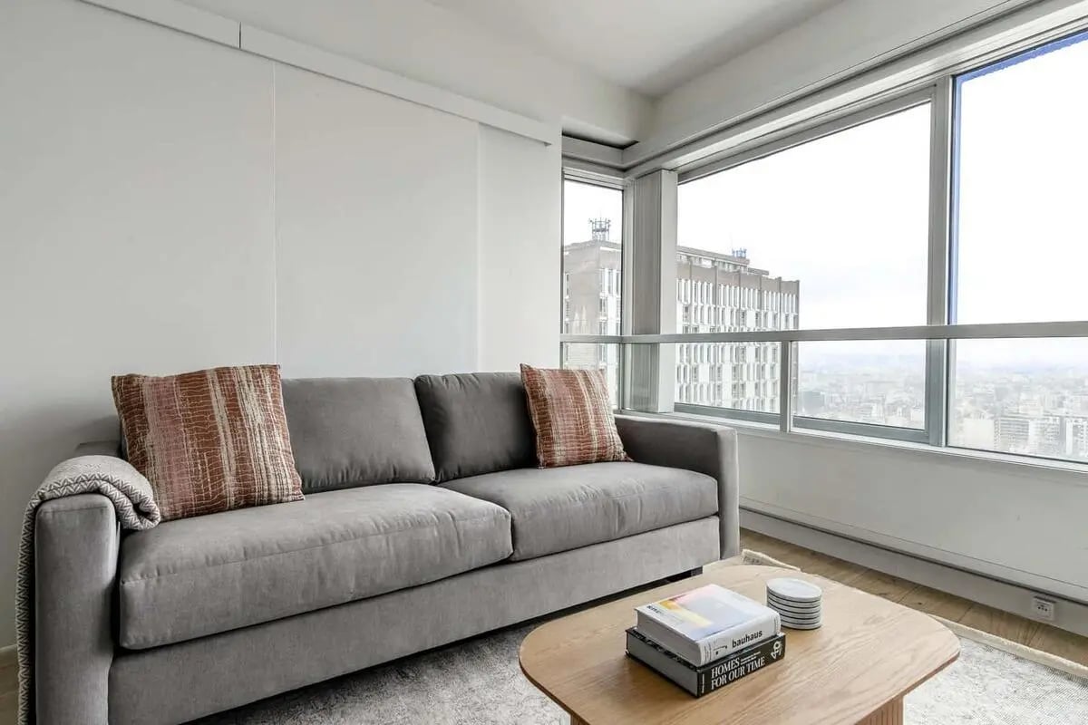 Grey sofa with patterned pillows coffee table living room at Apartment in 25 Quai André Citroën, 75015 Paris, France in Paris Student Accommodation