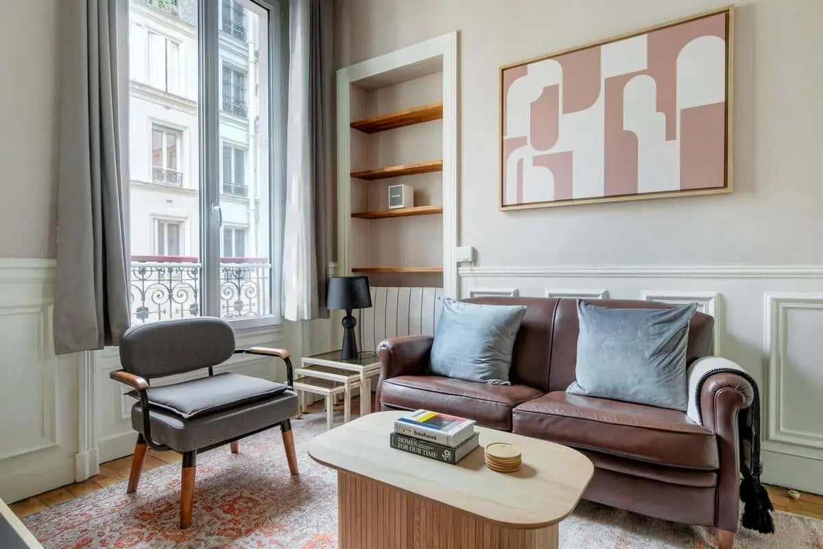 Sofa coffee table armchair art living room at Apartment in Île-de-France, 7 Rue du Louvre, 75001 Paris, France in Paris Student Accommodation