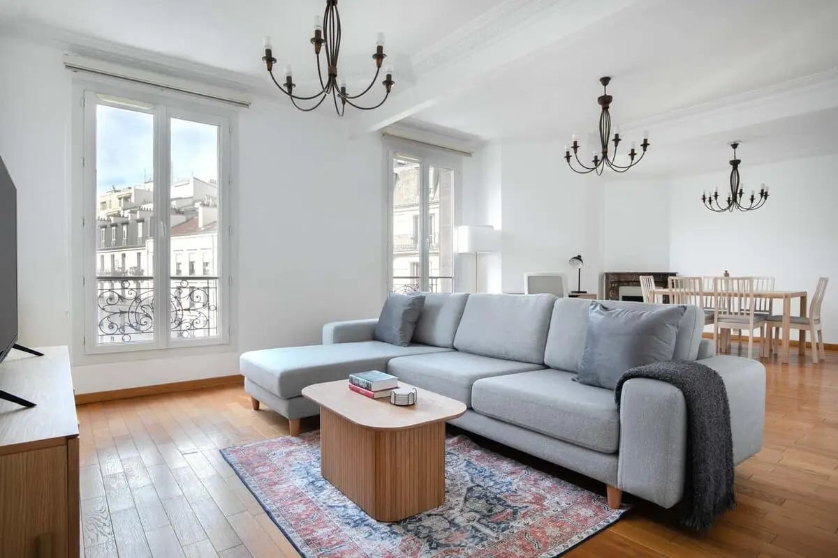 Gray sectional sofa wooden coffee table rug living room at Apartment in 41 Rue de la Procession, 75015 Paris, France in Paris Student Accommodation