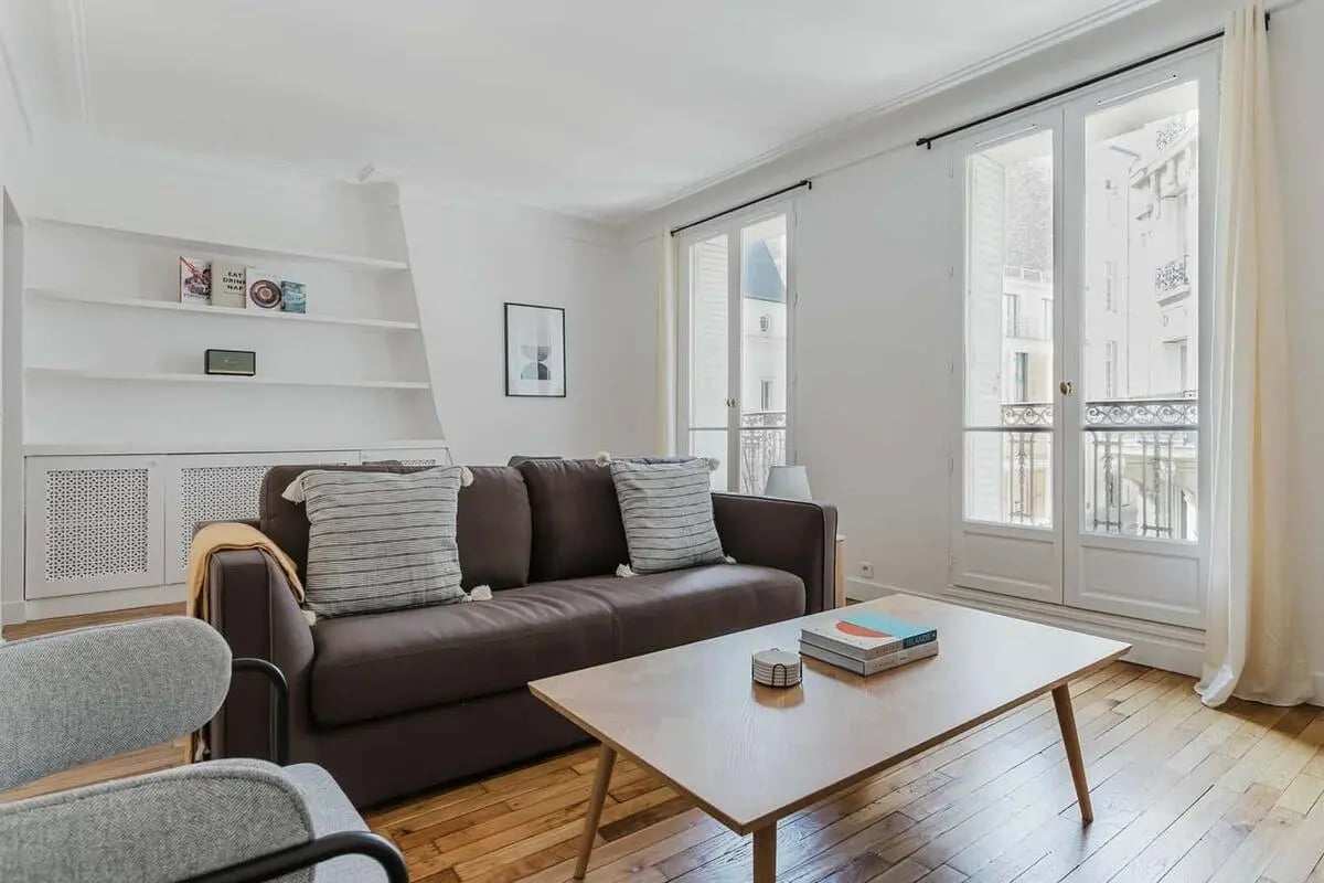Brown sofa with striped pillows living room living room at Apartment in 48 Rue Lamarck, 75018 Paris, France in Paris Student Accommodation