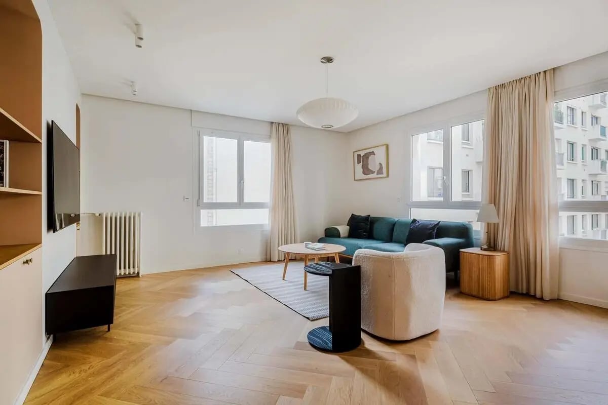 Turquoise sofa and chair with wooden coffee table living room at Apartment in 13 Av. Franco-Russe, 75007 Paris, France in Paris Student Accommodation