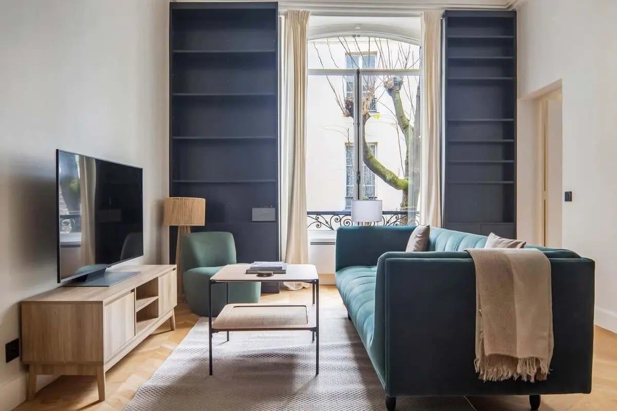Teal sofa and tv console living room at Apartment in 4 Cité Martignac, 75007 Paris, France in Paris Student Accommodation