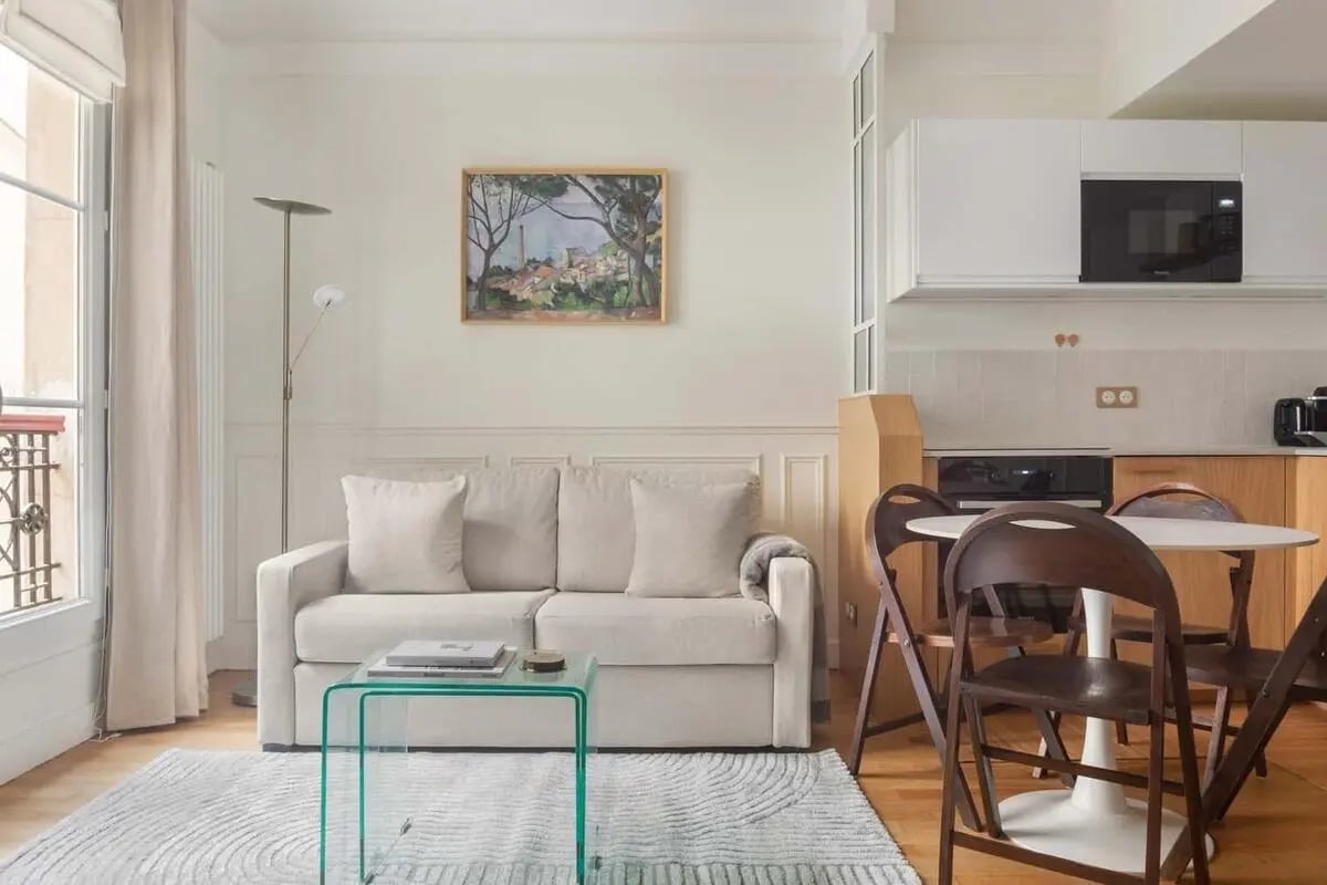 Sofa coffee table rug kitchen dining area living room at Apartment in 5 Bd de Port-Royal, 75013 Paris, France in Paris Student Accommodation