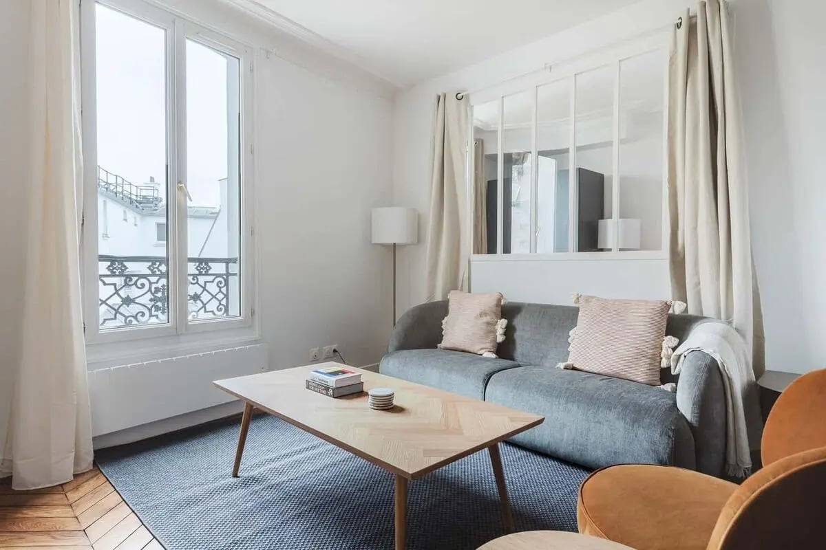 Sofa coffee table rug and window living room at Apartment in 11bis Rue du Mont-Cenis, 75018 Paris, France in Paris Student Accommodation