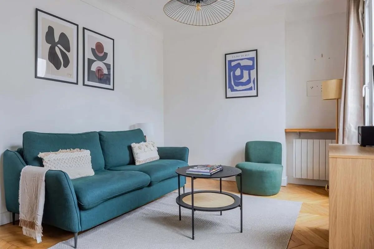 Teal sofa artwork coffee table living room at Apartment in 25 Rue du Champ de Mars, 75007 Paris, France in Paris Student Accommodation