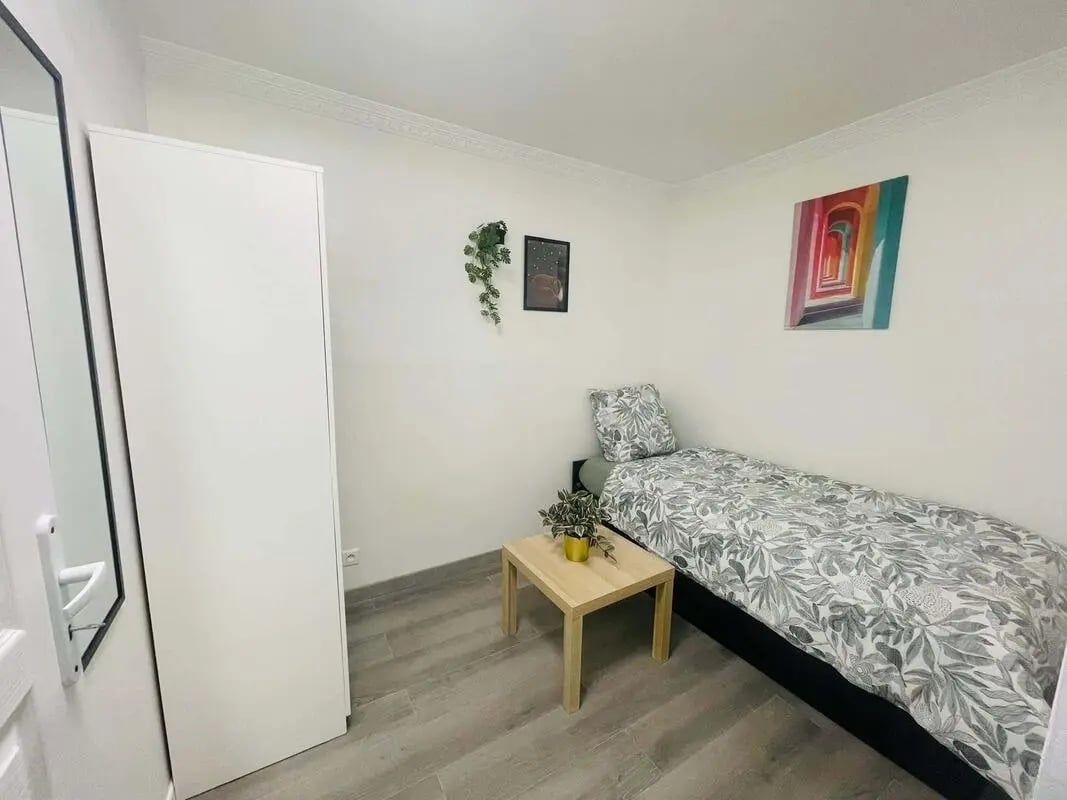White wardrobe single bed wooden table bedroom at Apartment in Rue Delizy, 93500 Pantin, Francia in Pantin Student Accommodation