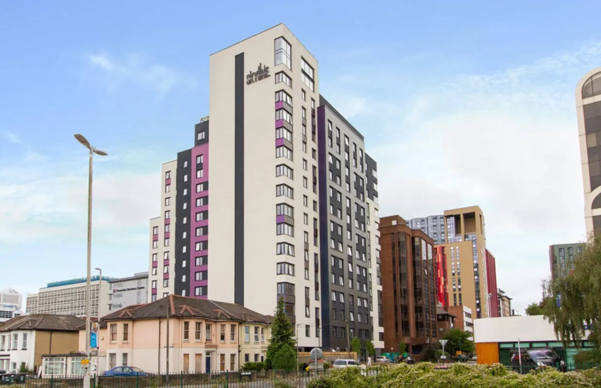 Modern student accommodation building with purple accents exterior at Skyline in Bournemouth Student Accommodation