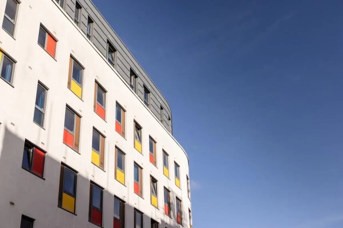 Modern building white exterior colorful windows exterior at Bournemouth University Village - Chesil House in Bournemouth Student Accommodation