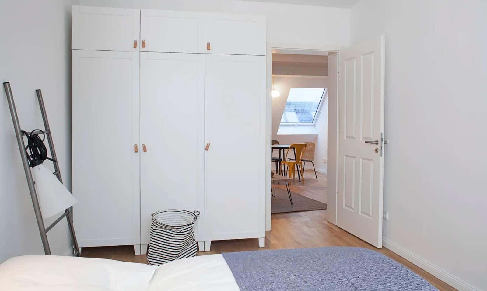White wardrobe with ladder and basket bedroom at Apartment in Dirschauer Str., 10245 Berlin-Bezirk Friedrichshain-Kreuzberg, Germany in Berlin Student Accommodation