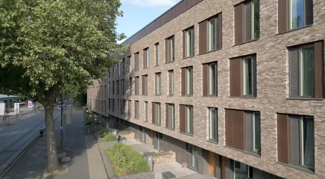 Brick building with multiple windows and shutters exterior at Graystacks in Nottingham Student Accommodation