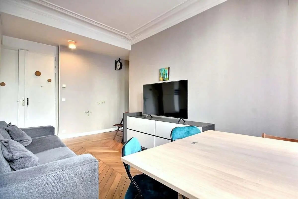 Sofa TV cabinet table and chairs living room at Apartment in Rue du Commerce, 75015 Paris, France in Paris Student Accommodation