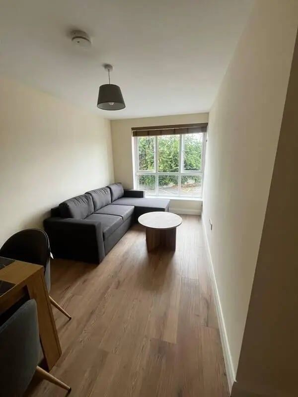 Dark sectional sofa and round coffee table living room at 16 Emmet Lodge, Emmet Court, Dublin 8 D08 EY83 in Dublin Student Accommodation