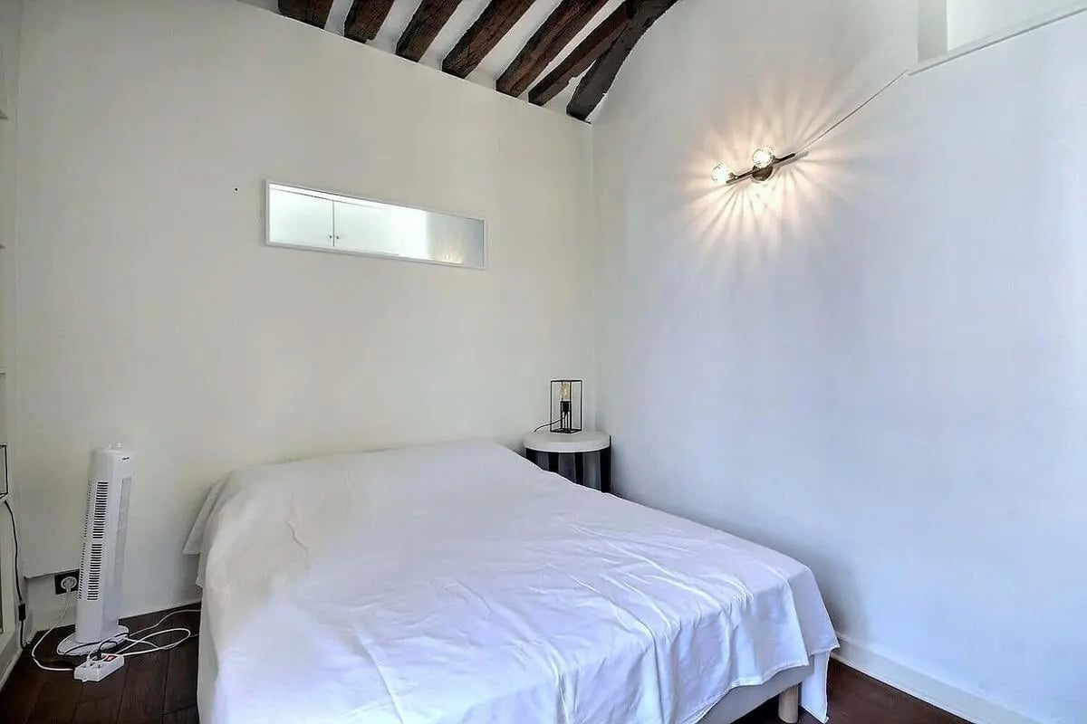 Bed fan lamp with bedside table bedroom at Apartment in Rue Dauphine, 75006 Paris, France in Paris Student Accommodation