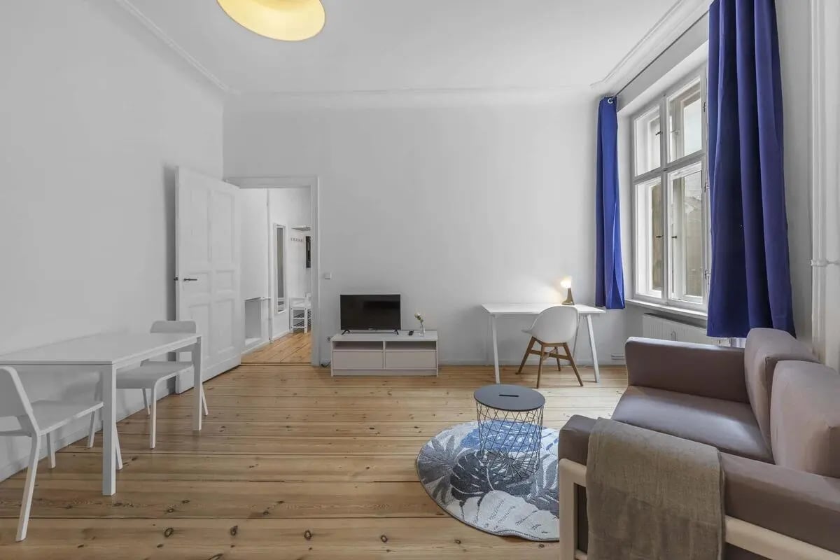 Sofa desk table and tv living room at Gabriel-Max-Straße - Studio Apartment in Berlin Student Accommodation