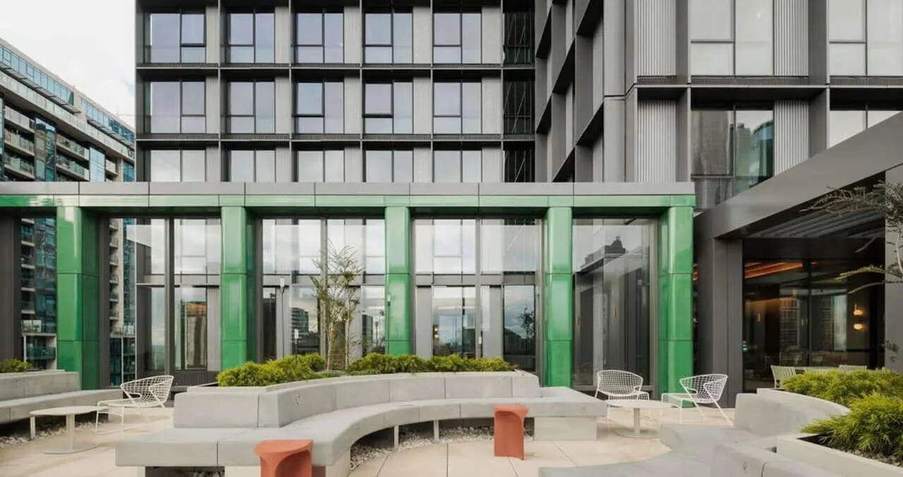 Outdoor seating with plants and modern building exterior area at Iglu Flagstaff Station in Melbourne Student Accommodation