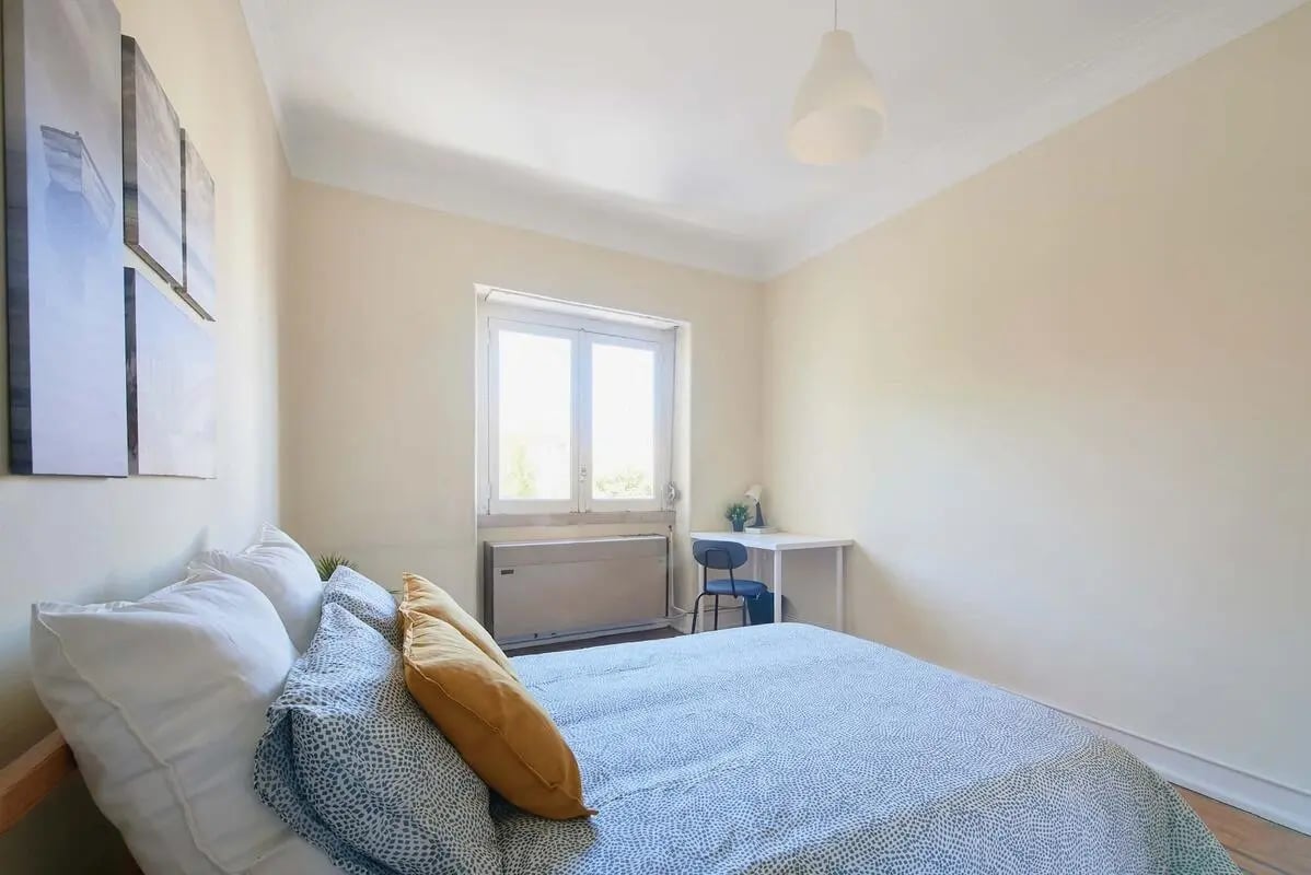 Bed with white pillows and blue duvet study desk bedroom at Bedroom in a 4-bedroom apartment in Lisbon - Room 2 in Lisbon Student Accommodation