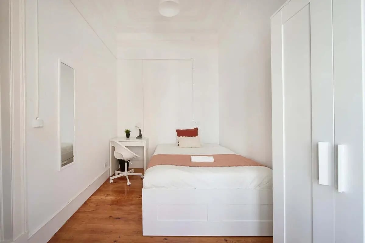 Bed desk chair mirror wardrobe bedroom at Bedroom in a 8-Bedroom Apartment in Rua Chaby Pinheiro, Lisbon - Room 1 in Lisbon Student Accommodation