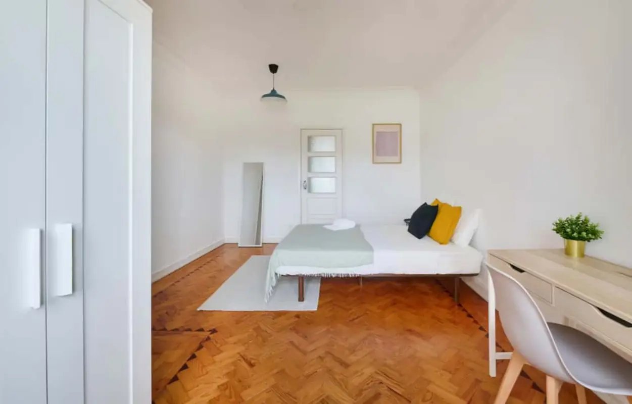 Bed desk plant and closet bedroom at Bedroom in a 5-bedroom apartment in R. Infante D. Pedro, Lisbon - Room 4 in Lisbon Student Accommodation