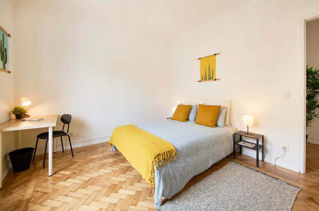 Bed desk chair and plant bedroom at Room in Rua marquesa da Alorna, Lisbon - Room 1 (2min from metro station) in Lisbon Student Accommodation