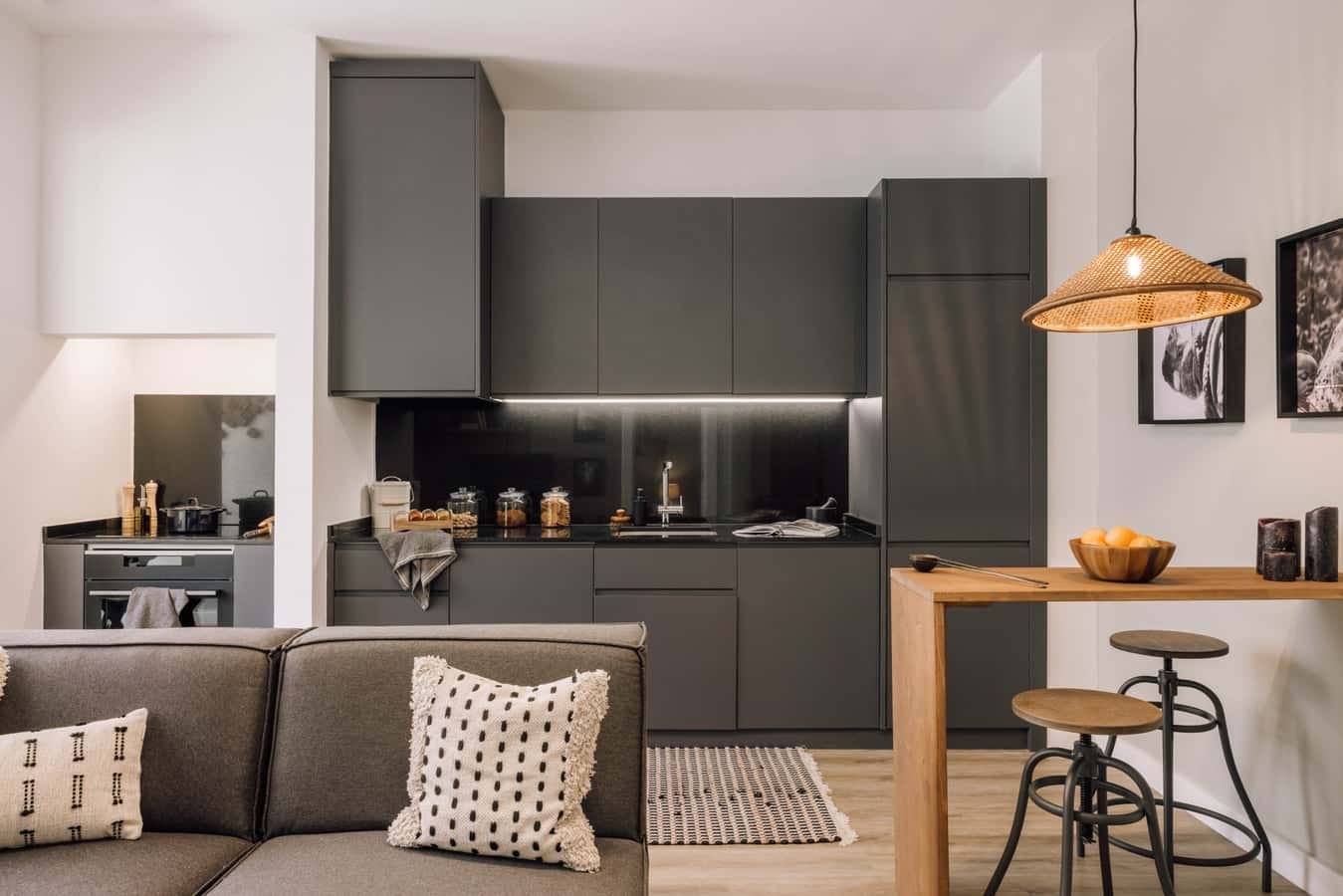 Gray cabinets counter and stools kitchen living room at 1 bedroom in Avenidas Novas in Lisbon Student Accommodation
